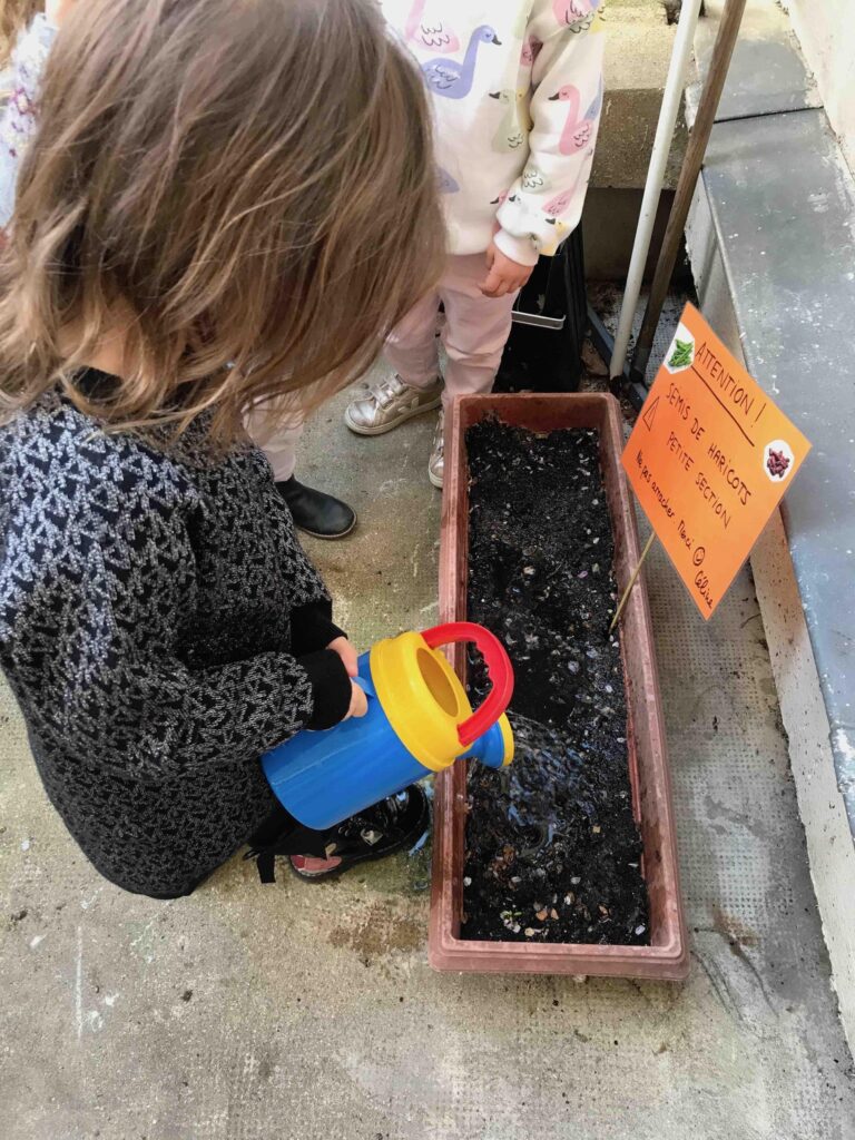 kid watering plant