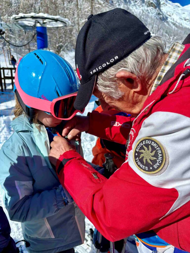 esf ski school presenting medal to child_the knowledge nuggets