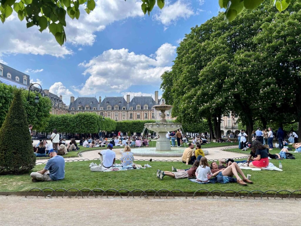 people relaxing in place des vosges